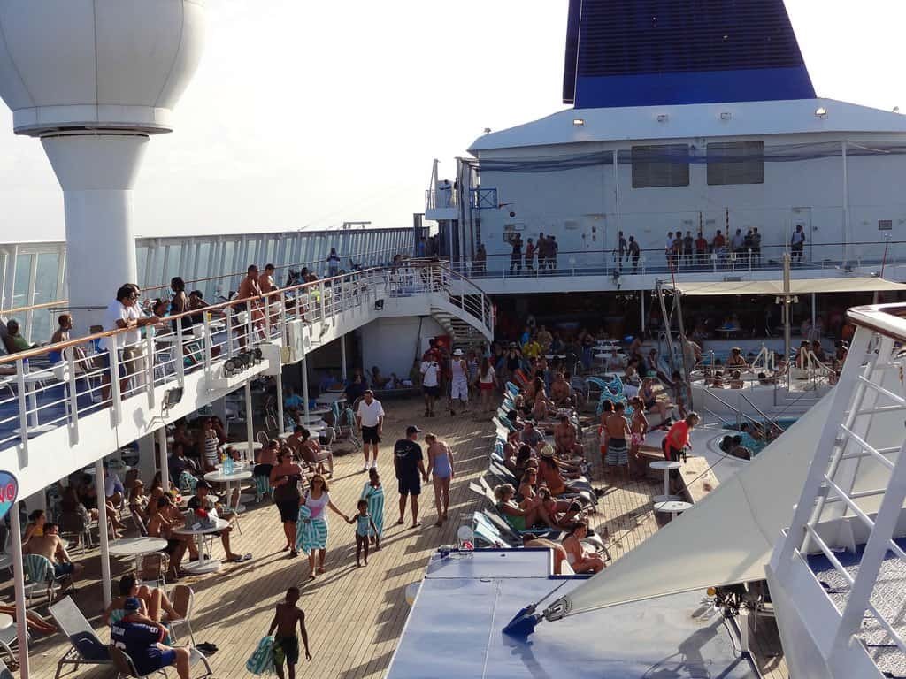 Norwegian Sky cruise ship deck with passengers relaxing and enjoying the sun.