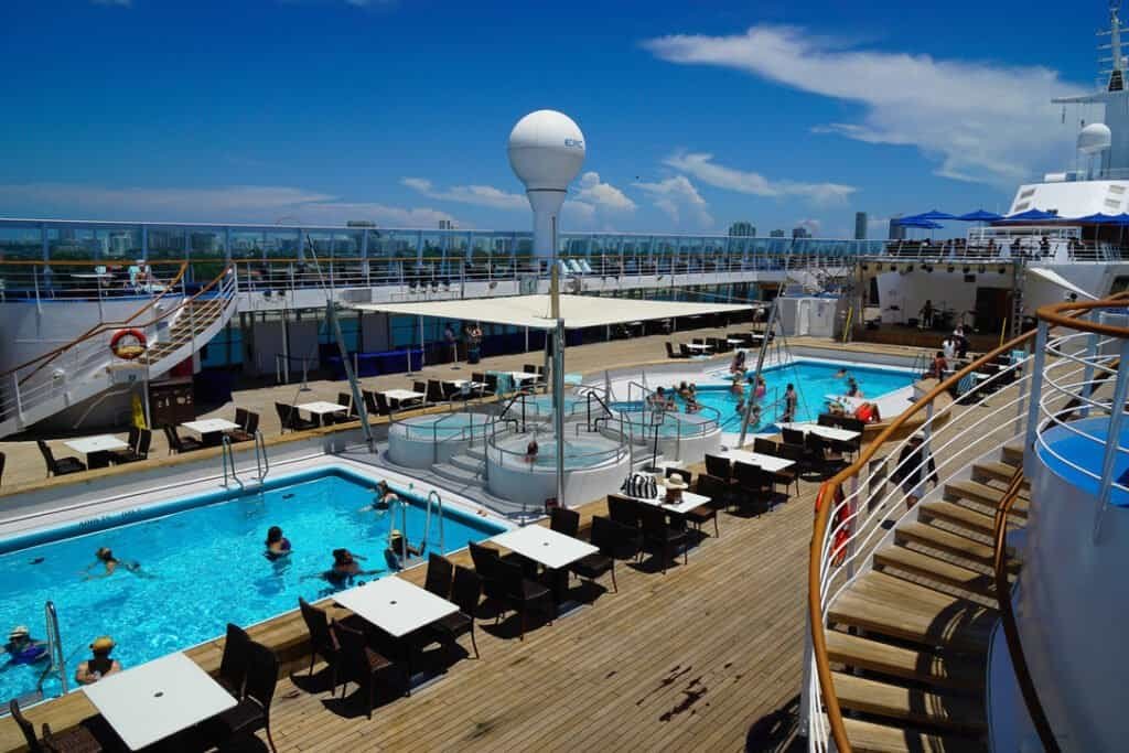 Pool area with swimmers on Norwegian Sky cruise ship.