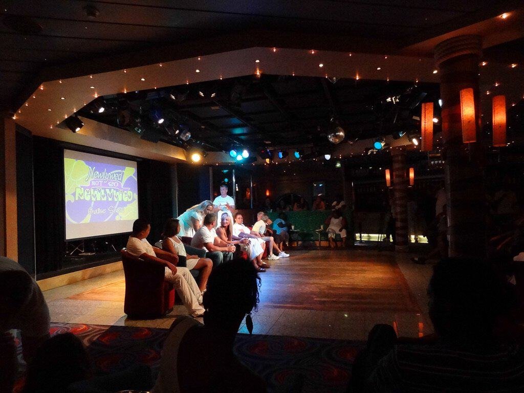 Passengers enjoying live entertainment on Norwegian Sky cruise ship deck.