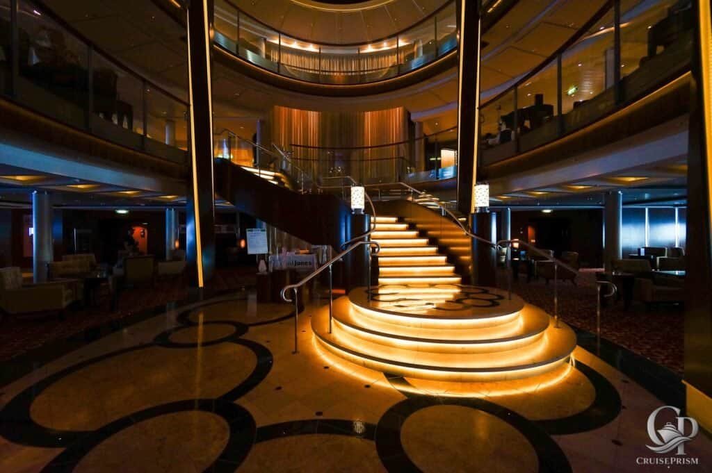 Celebrity silhouette cruise ship interior featuring illuminated staircase and modern decor.