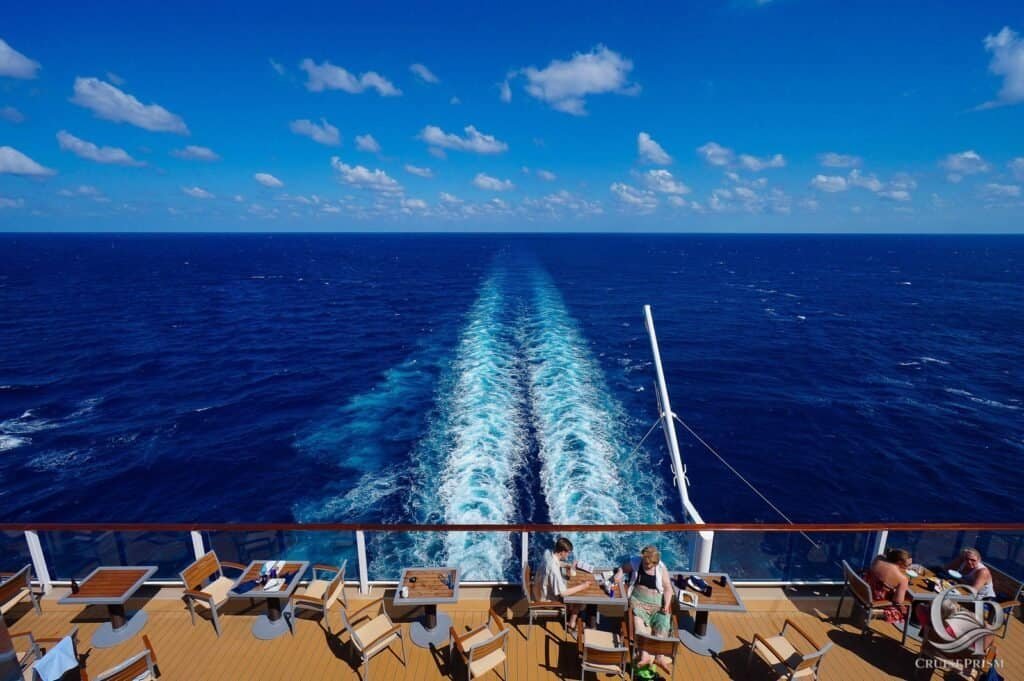 Celebrity silhouette ship deck with outdoor seating, sunbathers, and a stunning ocean view under a bright b.