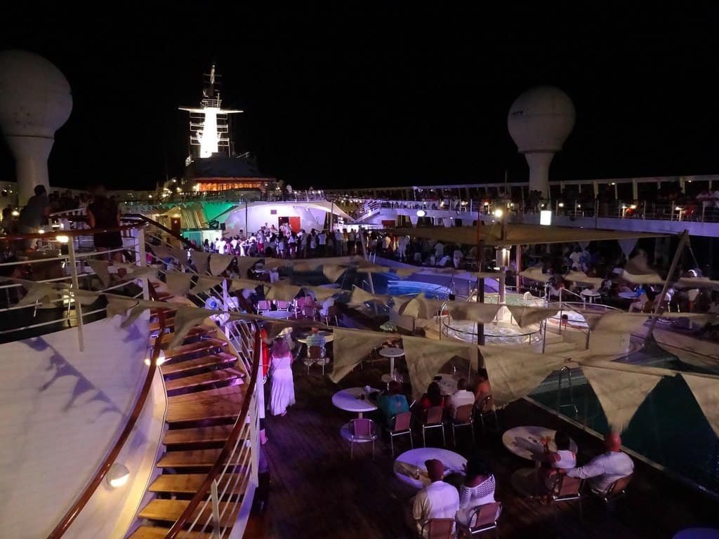 Sunset deck with lounge chairs and umbrellas on Norwegian Sky cruise ship.
