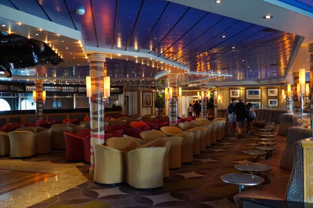 Luxurious cruise lounge with modern decor and ambient lighting.