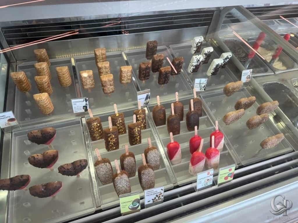 Delicious assorted chocolate ice cream bars and treats in a display case on a cruise ship.