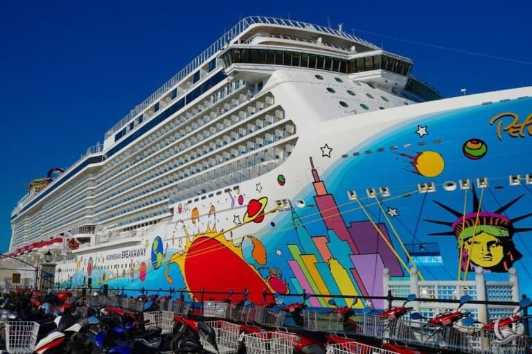 Norwegian Breakaway cruise ship with colorful space-themed artwork on the hull.