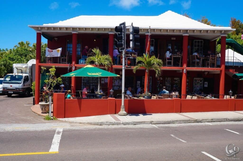 Outdoor dining at a coastal restaurant with a two-story patio and vibrant umbrellas.