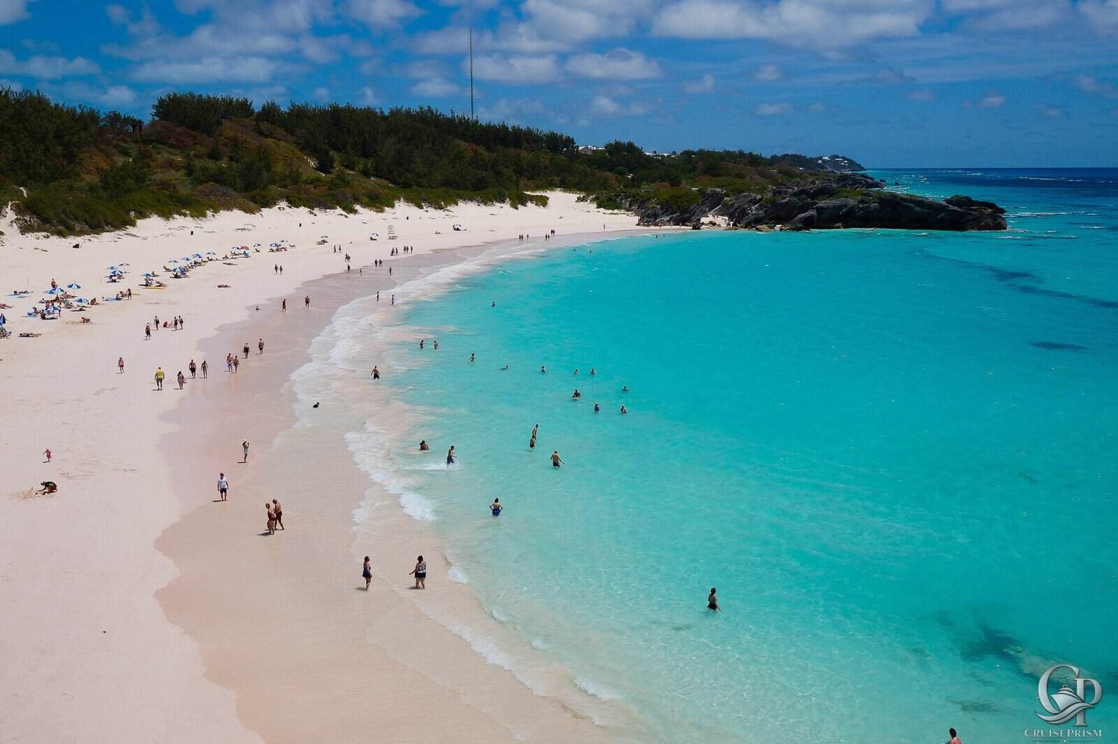 Horseshoe Bay Beach with turquoise waters and white sand, popular cruise destination.