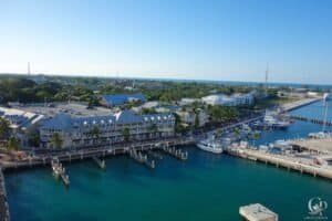 Marina with yachts, waterfront buildings, and scenic coastal views.