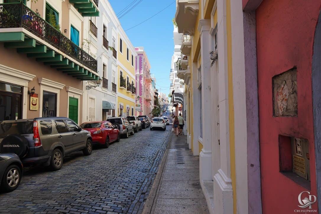Historic colorful street in Old San Juan, Puerto Rico, with vibrant buildings and cobblestone paveme.